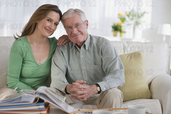 Father an daughter looking at photo albums.