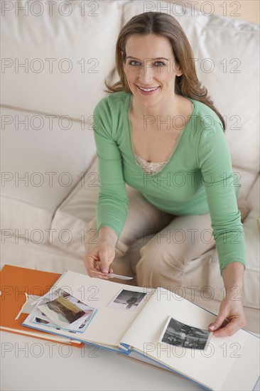 Woman looking at photo album.