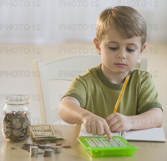 Boy calculating personal finances.