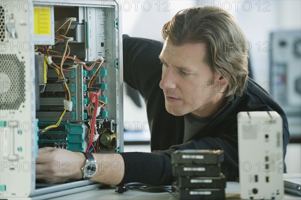 Technician repairing computer.