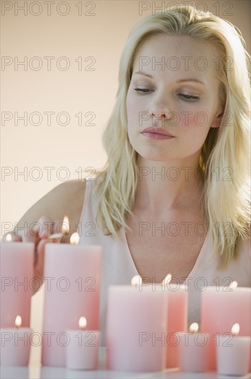 Woman lighting candles.