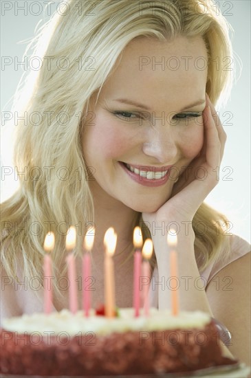 Woman celebrating birthday with cake.