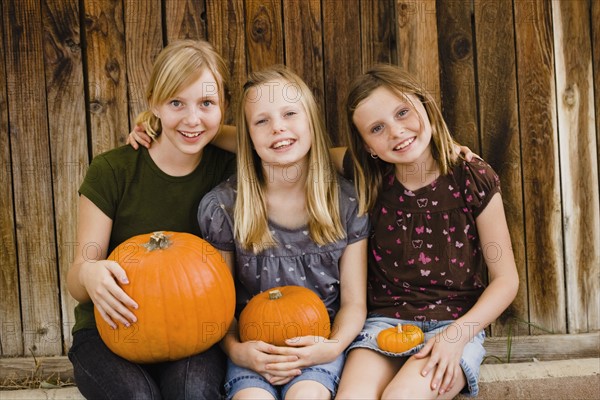 Girls holding pumkins