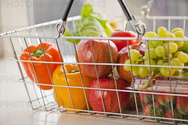 Paper bag filled with vegetables and fruits.