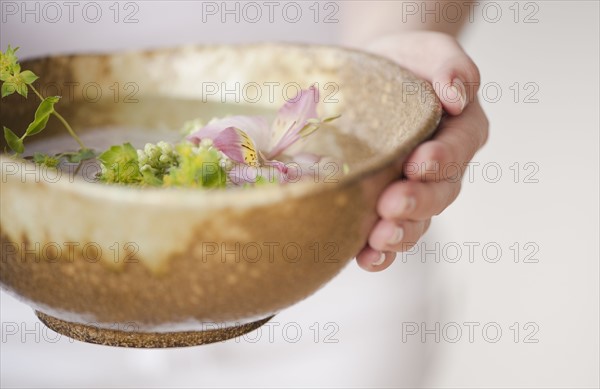 Woman holding aromatherapy bowl.