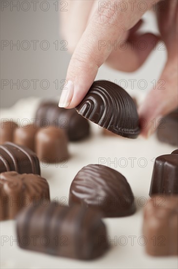 Woman's hand holding chocolate.