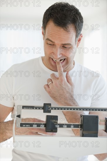 Mature man on scales.