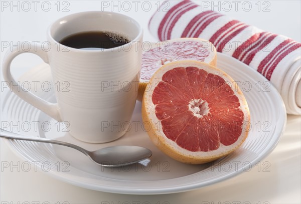 Blueberry cake with coffee cup in background.