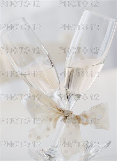 Champagne glasses tied with ribbon. Photographe : Jamie Grill
