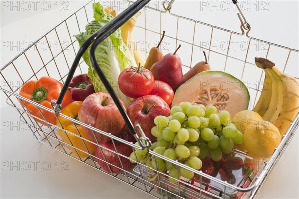 Paper bag filled with vegetables and fruits.