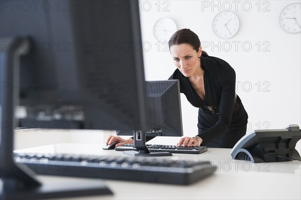 Businesswoman at work using computer.