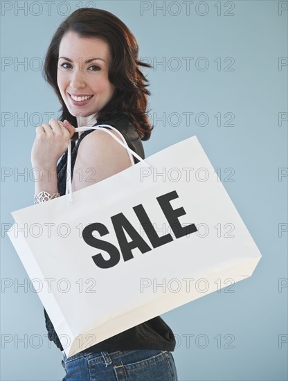 Woman holding shopping bag.