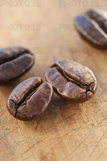 Four roast coffee beans, studio shot.