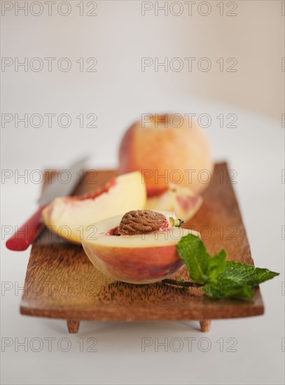 Sliced peach on chopping board.