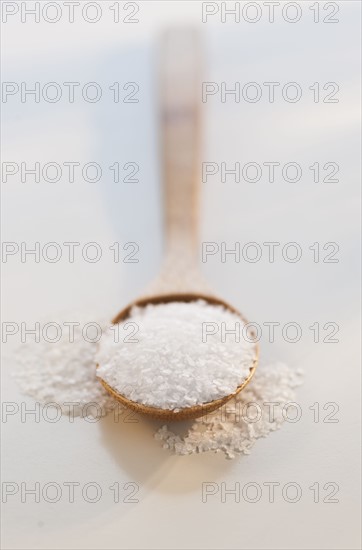 Wooden spoon of salt, studio shot.