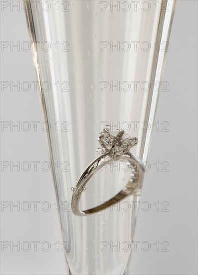 Engagement ring in champagne glass. Photographe : Jamie Grill