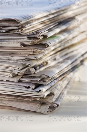 Pile of newspapers for recycling, studio shot. Photographe : Daniel Grill