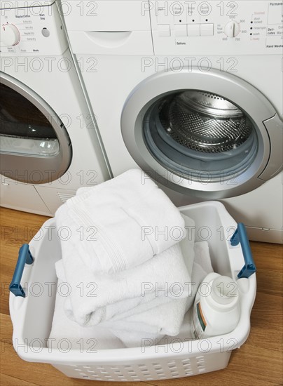 Laundry in basket in launderette.