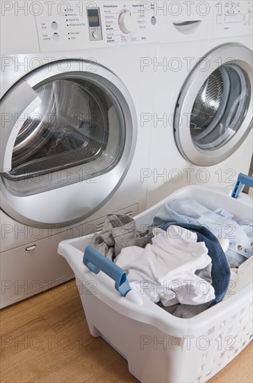 Laundry in basket in launderette.