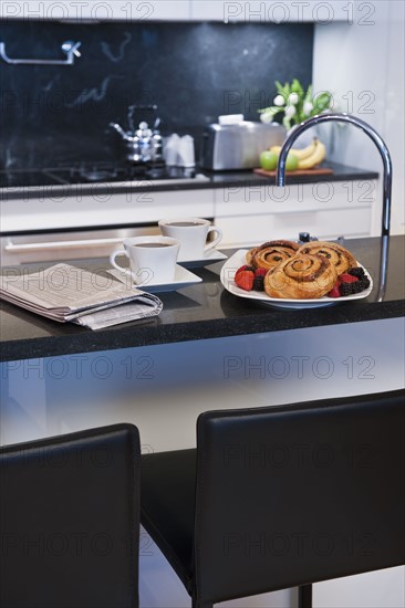 Cinnamon buns on kitchen worktop.