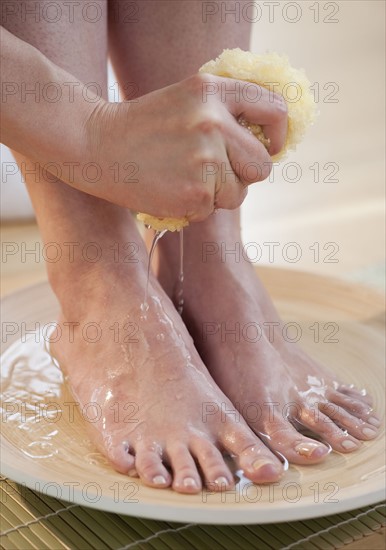 Close-up of woman washing feet.