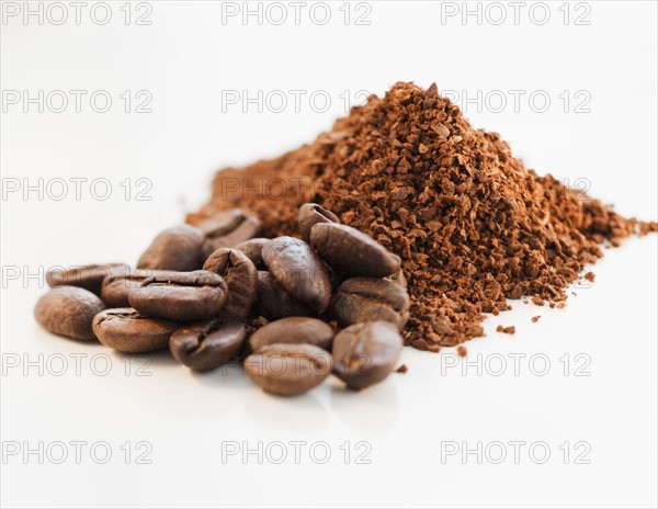 Heap of coffee beans and ground coffee.