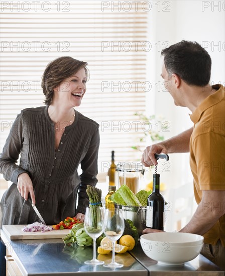 Couple preparing food in kitchen.