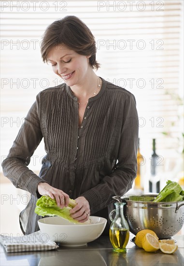 Woman preparing food in kitchen.