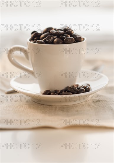 Coffee beans in cup.
