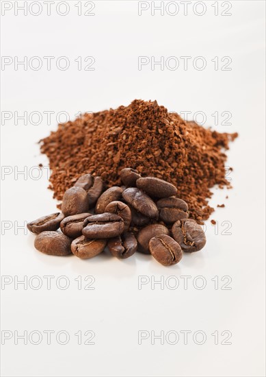 Heap of coffee beans and ground coffee.