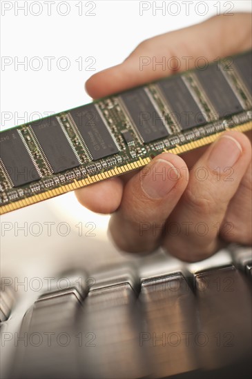 Hand holding computer chips.