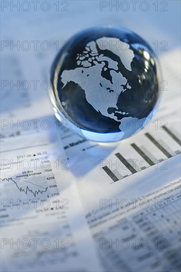 A globe on business papers.