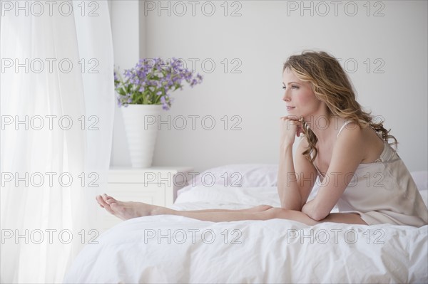 A woman relaxing in bed.
