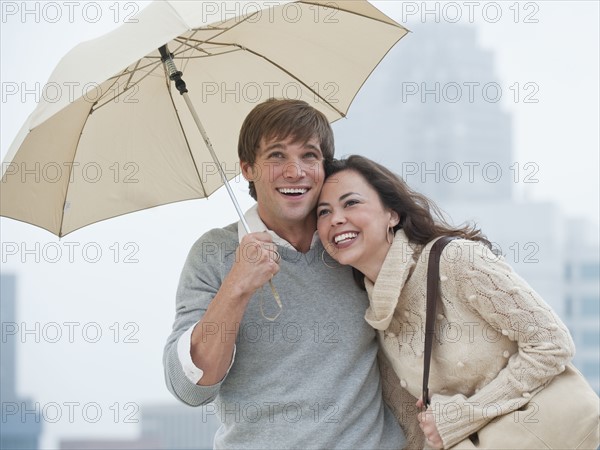 A couple outdoors in the rain.