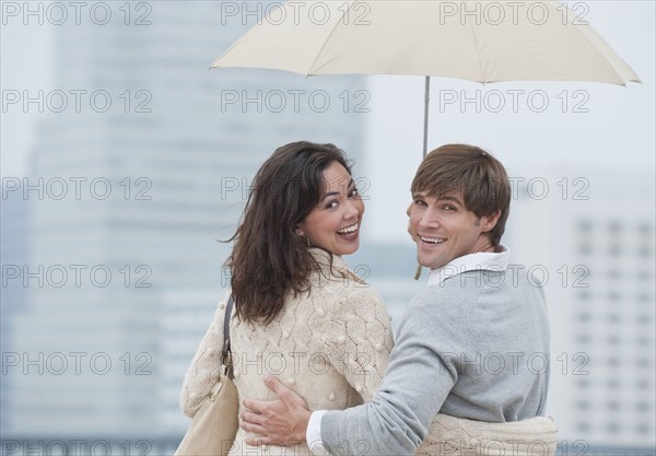 A couple outdoors in the rain.