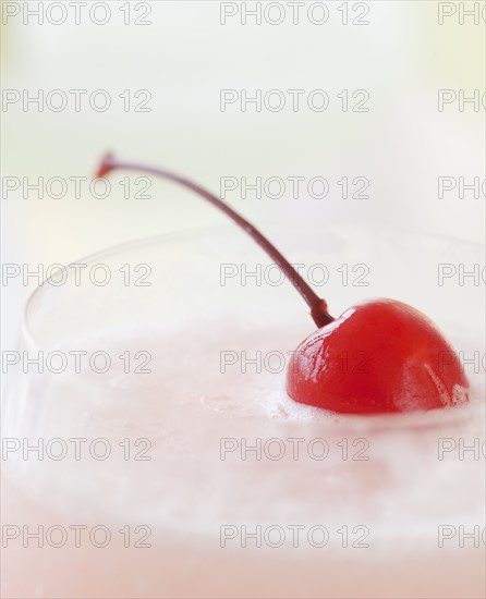 A milkshake with a cherry