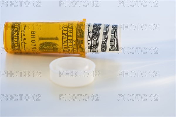 Pill bottle with bank notes