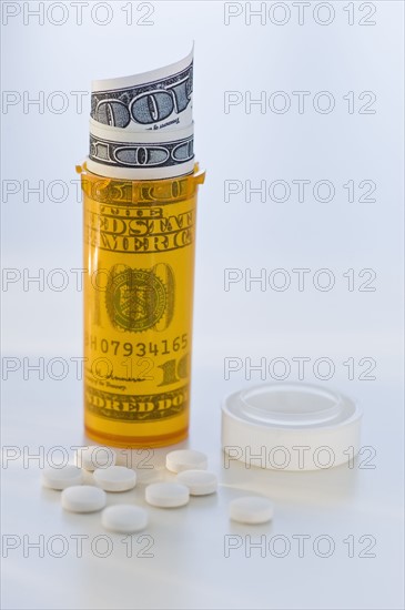 Pill bottle with bank notes