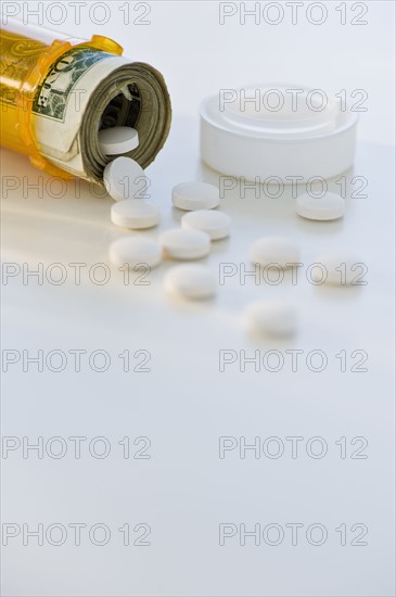 Pill bottle with bank notes