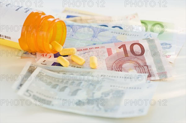 Pill bottle with bank notes