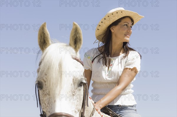 A woman riding a horse