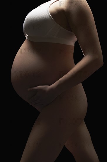 Pregnant woman holding belly