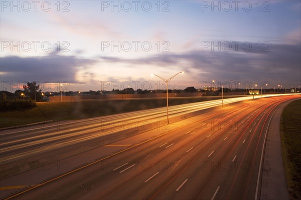 A road with tail light trails