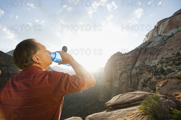 A man drinking water at Red Rock