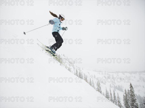 A downhill skier jumping