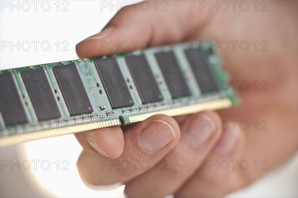 Hand holding computer chips.