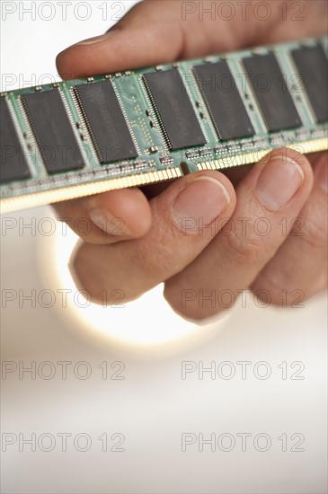 Hand holding computer chips.