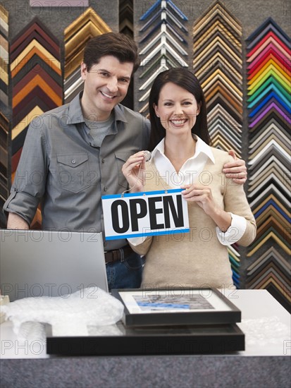 A woman and man at a frame store.