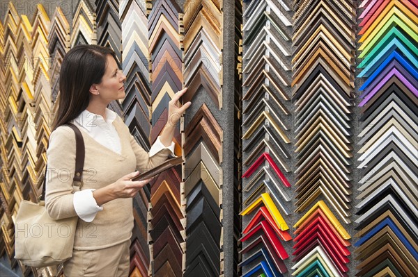 A woman browsing at a frame store.