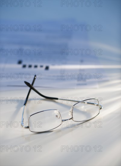 Eyeglasses near some paperwork.